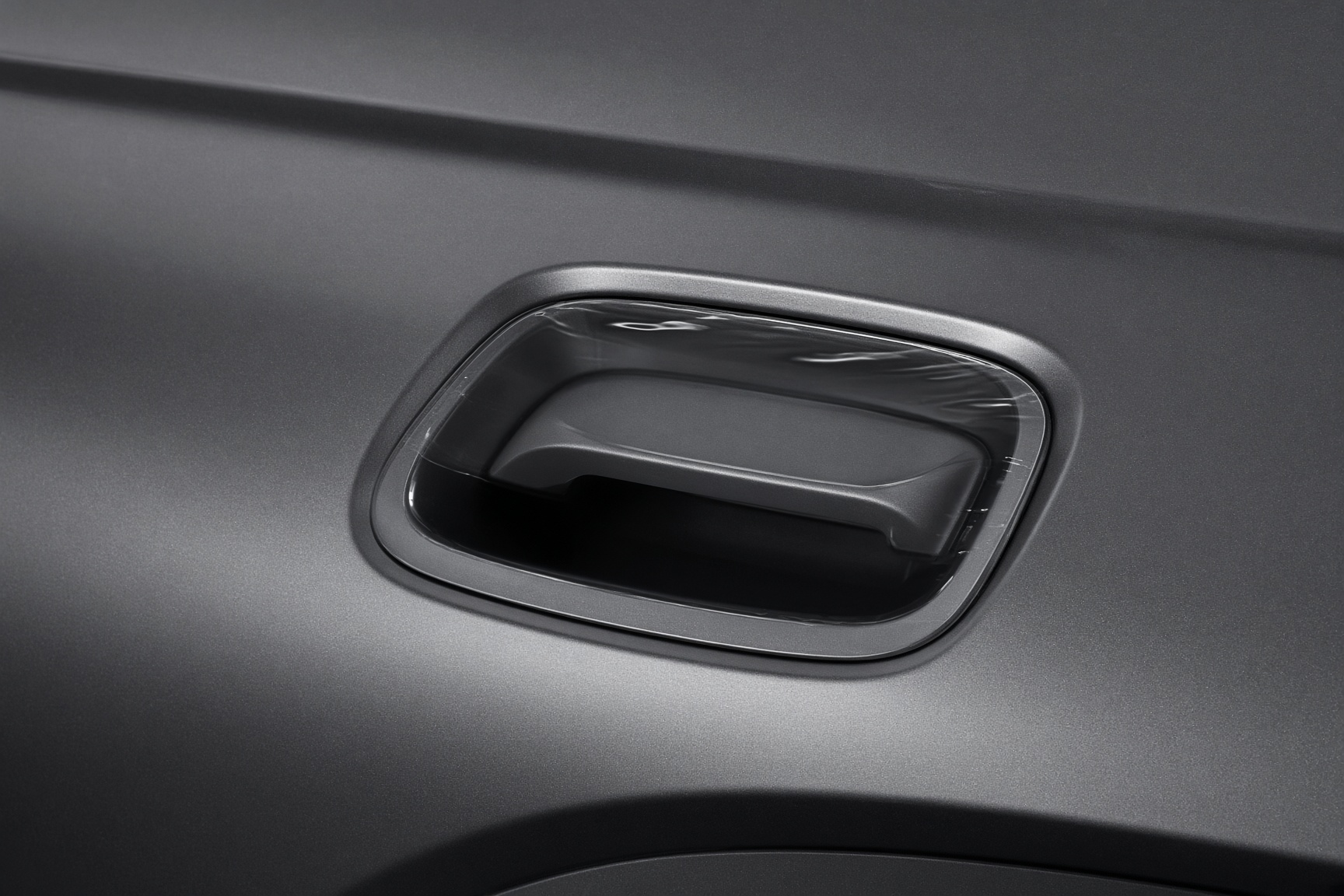Clear protective film in a vehicle door handle cup